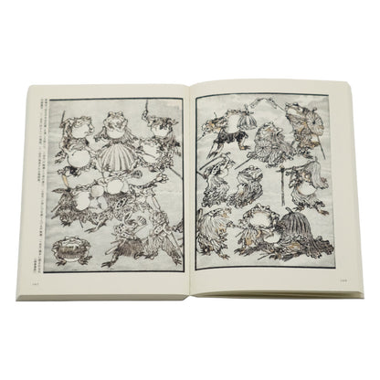 Open book with black and white illustrations on a white background