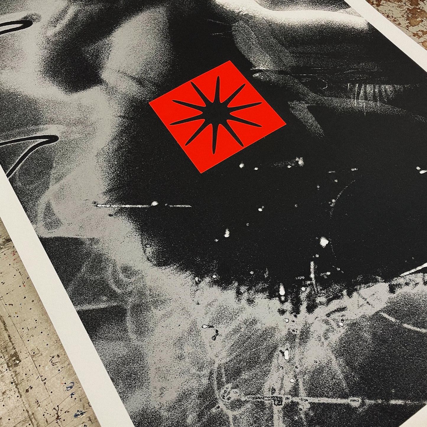 Black and white aerial view of a city with a red star symbol overlay